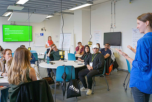 Speaking woman in front of public 