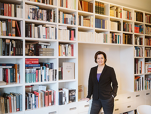 Regine Buchheim steht vor einer Bücherwand