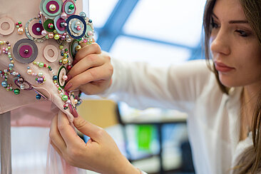 Martha Berwanger working on her dress