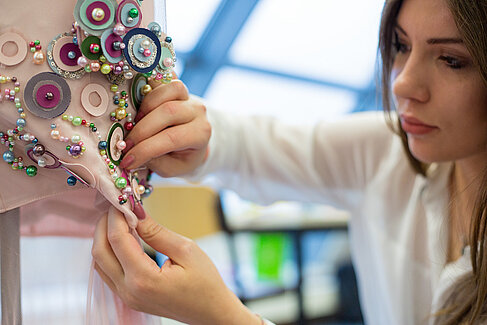 Martha Berwanger working on her dress