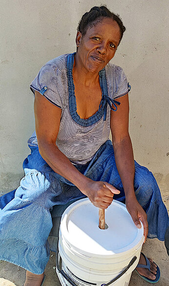 Woman with bucket washing machine
